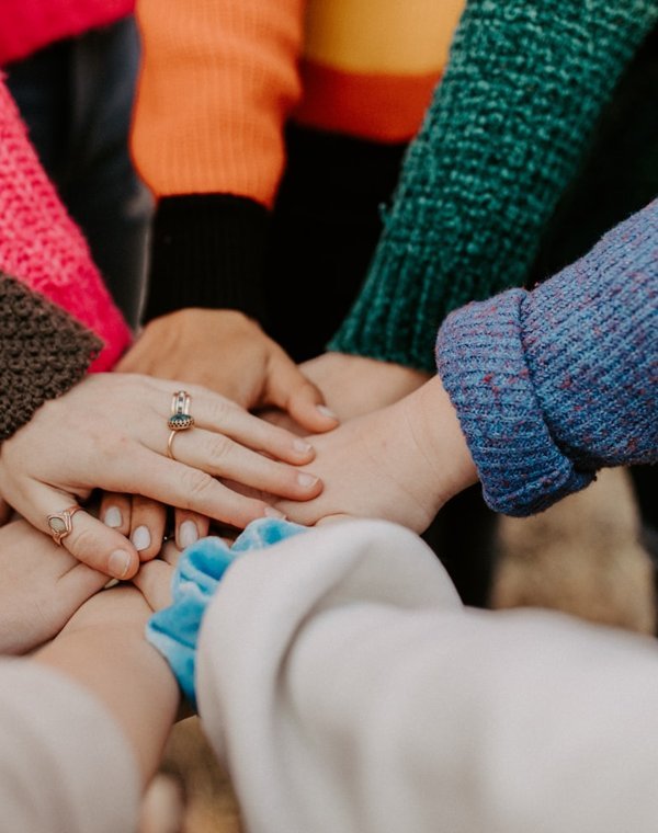 Hands of a diverse Ottawa community group joined together